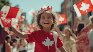 A child celebrating Canada Day wearing a red tshirt with a white maple leaf